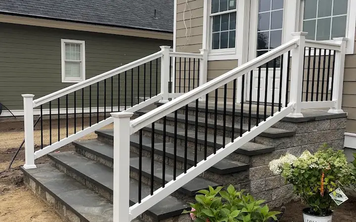 White vinyl railing with black balusters on front steps