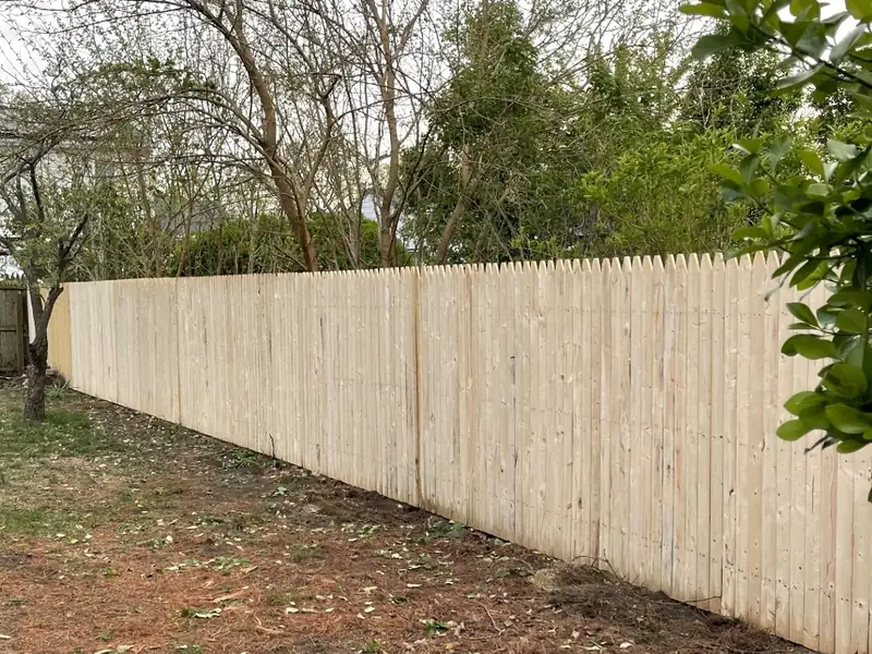 Long run of new wood stockade fence