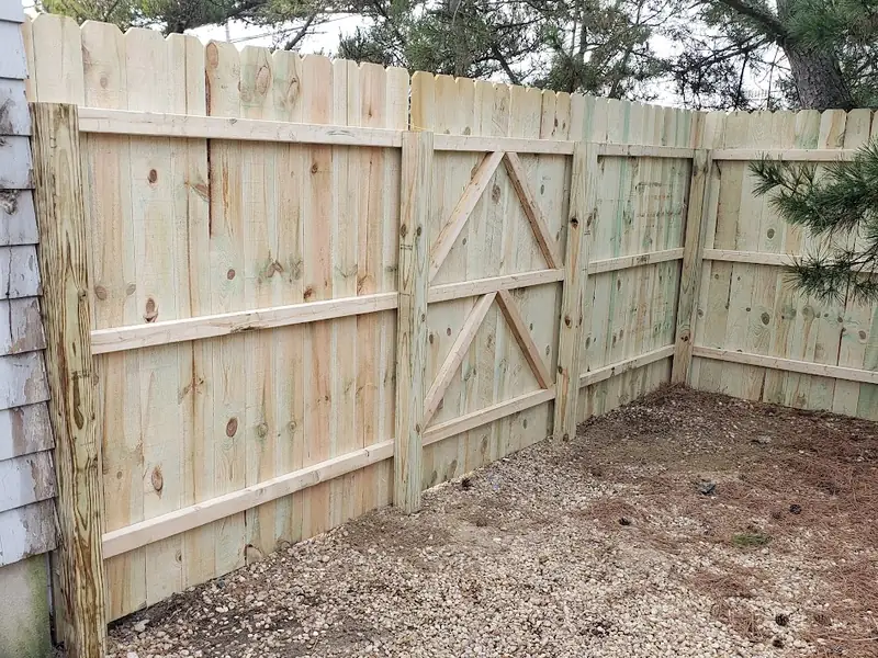 Wood privacy fence with a braced gate